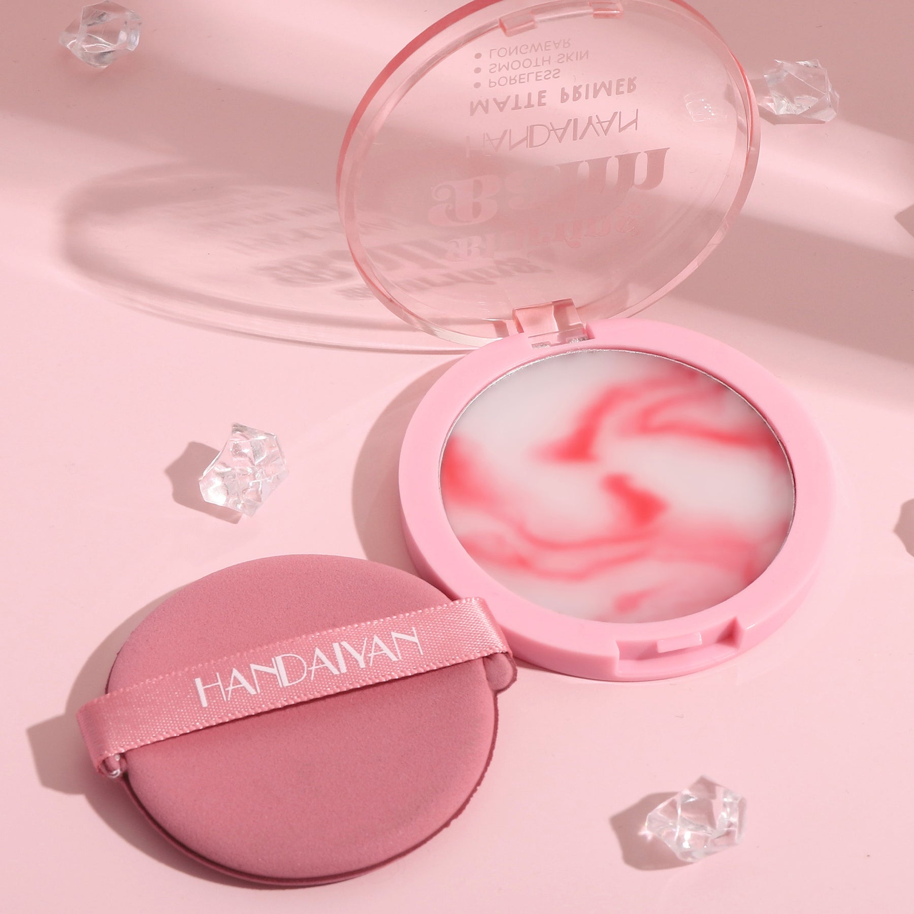 polvo compacto en crema con empaque rosa y esponja incluida